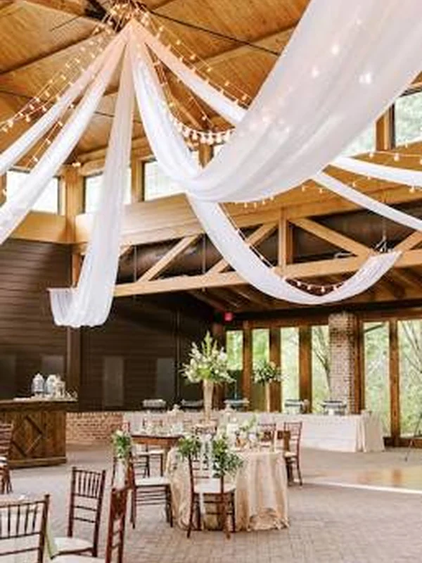 Warm wood reception setting with white draping